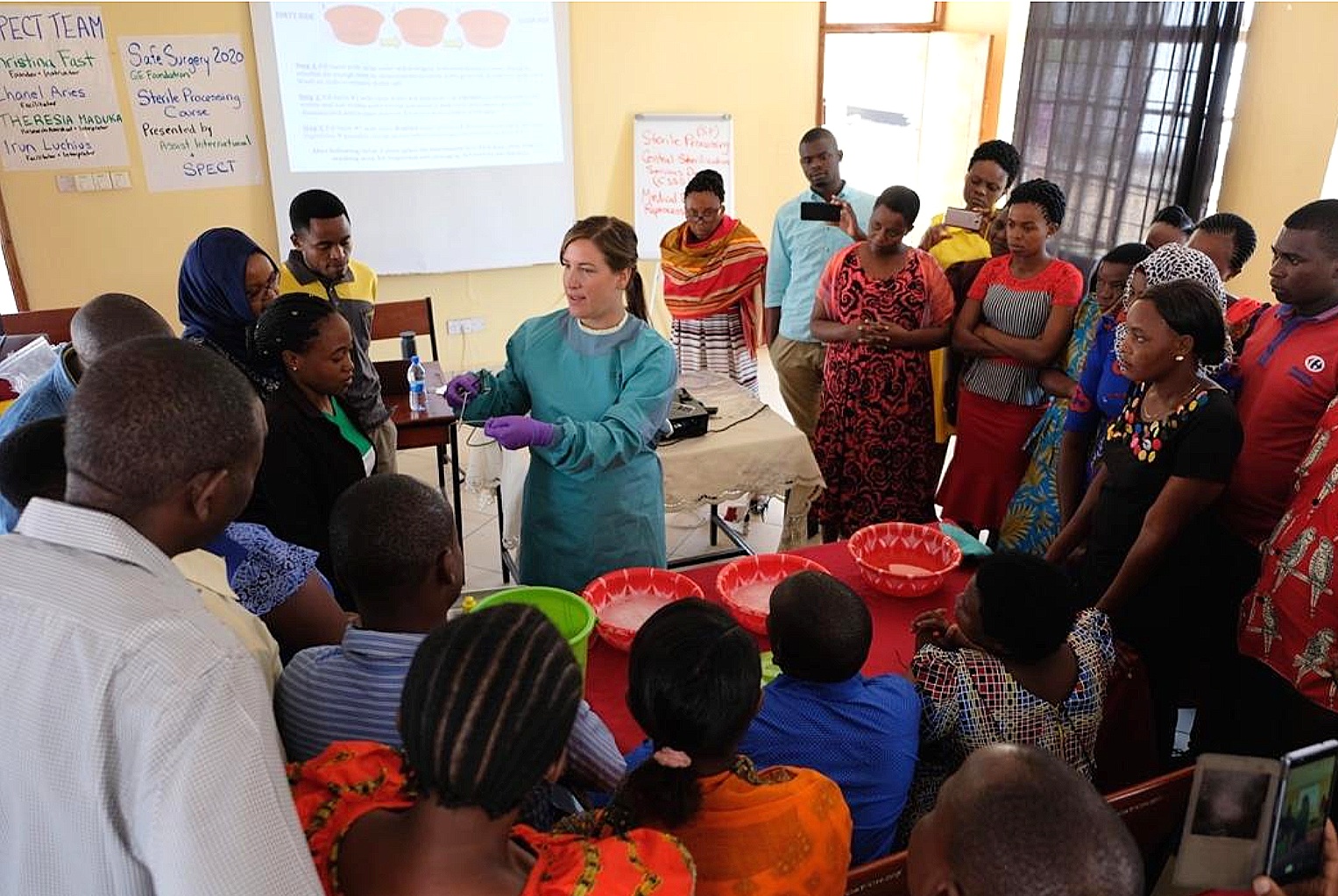  Fast demonstrates the manual instrument cleaning method to Tanzanian training participants. 
